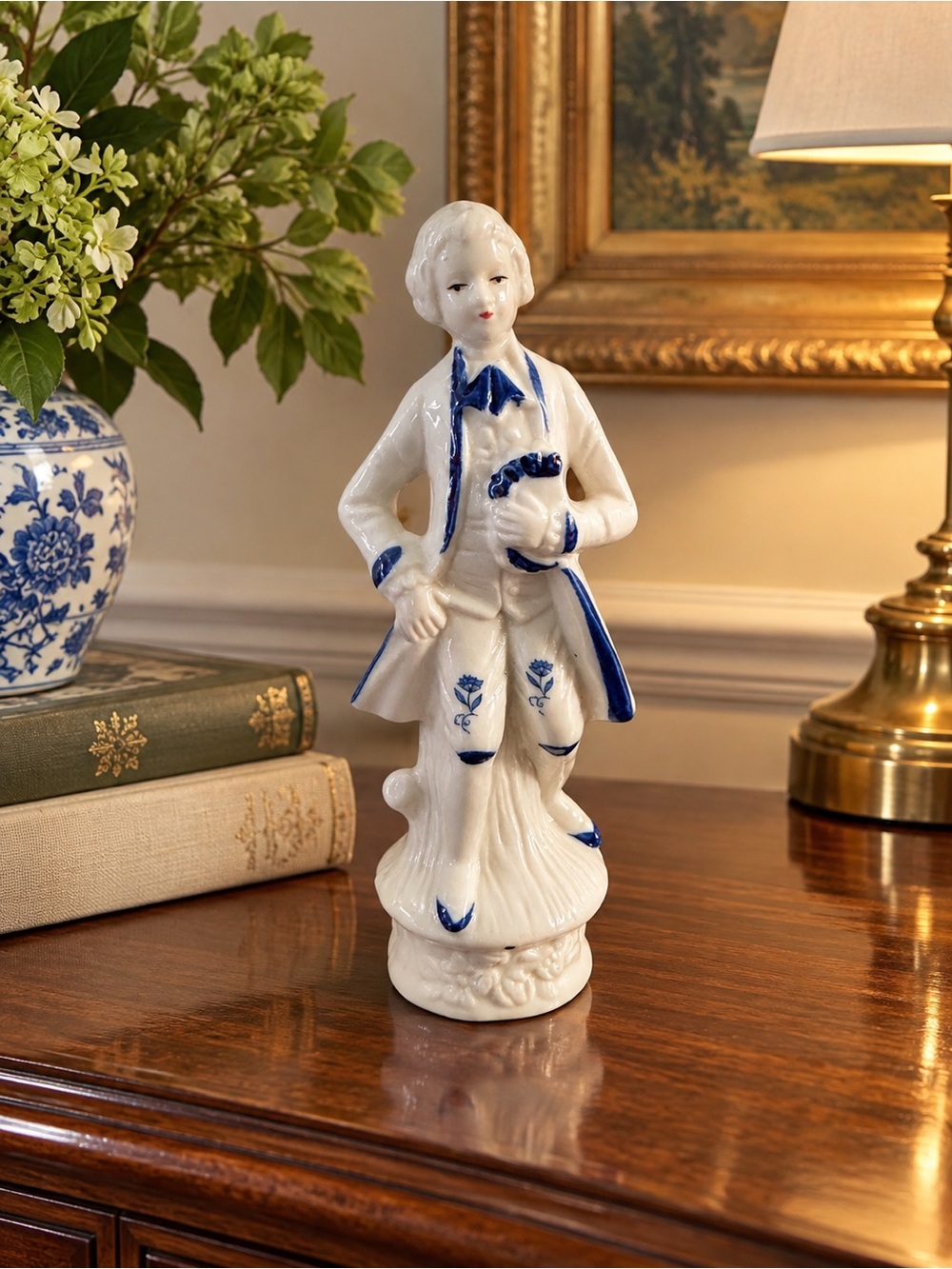 vintage white porcelain figurine in an 18th-century or colonial style, featurin